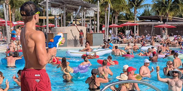 Virgin Voyages Happenings Cast member amping up a pool party at Bimini Beach Club